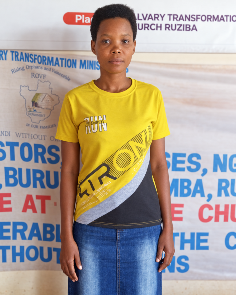 Nadine Nkeshimana, the school’s secretary and accountant, wearing a yellow shirt in front of ministry banners.